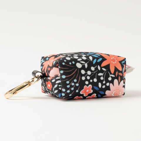 Floral patterned pouch with a keychain on a wooden surface