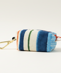 Striped pouch with a carabiner on a light wooden surface