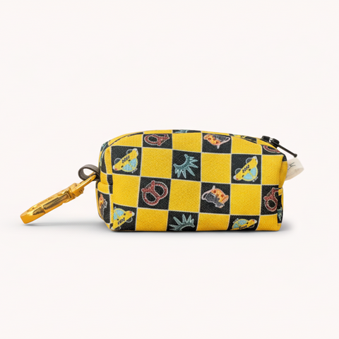 Yellow and black checkered pouch with cartoon character designs on a wooden surface