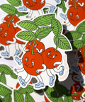 Sticker of cherries with faces and leaves on a patterned background