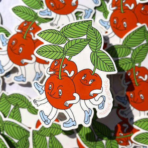 Sticker of cherries with faces and leaves on a patterned background