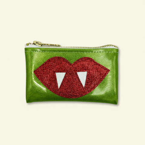Green pouch with red lips and white fangs design