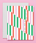 Striped holiday greeting card with 'Holiday Greetings' text on a pink background