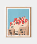Framed artwork with 'New Yorker' text on a building against a blue sky.