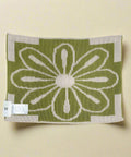 Green and beige patterned fabric with a floral design on a white background