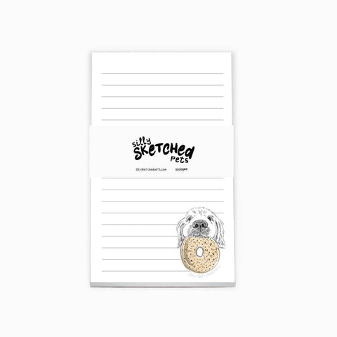 Notepad with an illustration of a dog holding a bagel in the bottom right corner.